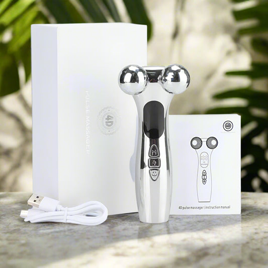 Silver handheld massager with USB cable on a white background